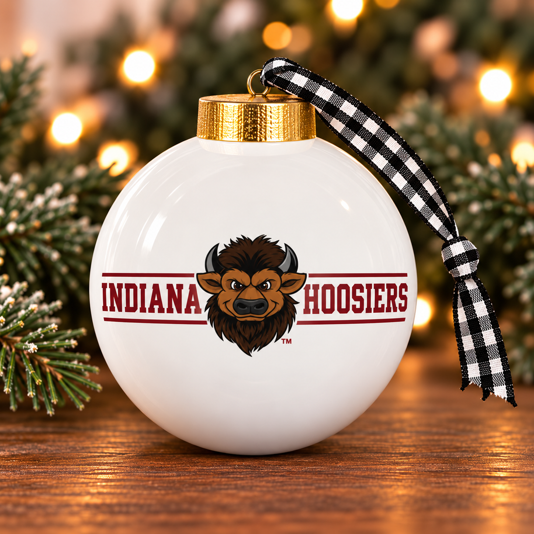 White Indiana Hoosiers bison-head ornament with gold-colored cap and black-and-white checked ribbon